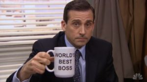 Michael Scott of NBC's The Office holding a "World's Best Boss" Mug