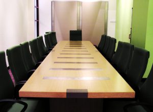 Large board room table with black chairs