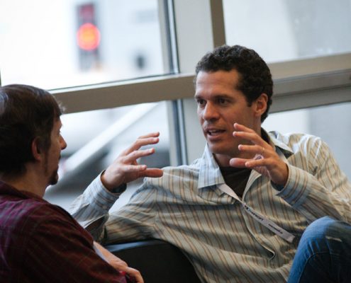 two business men sitting and talking