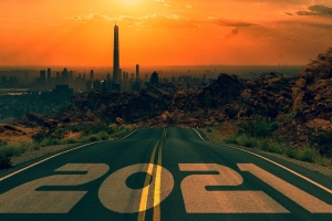 2021 imposed on a road leading to cityscape w sunset