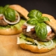 two gourmet hamburgers with basil